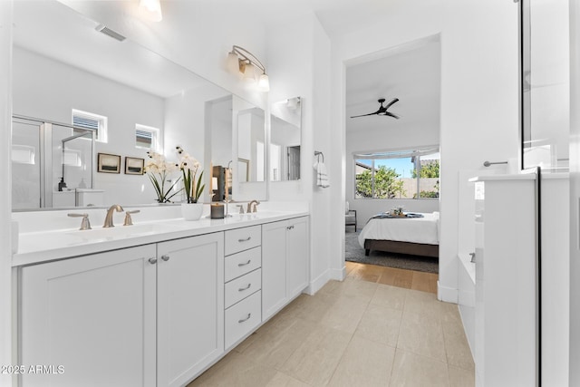 bathroom with vanity, a shower with door, and ceiling fan