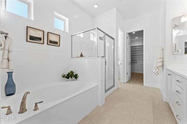 bathroom with vanity, tile patterned floors, and shower with separate bathtub