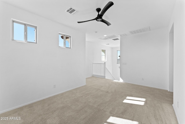 carpeted empty room featuring ceiling fan