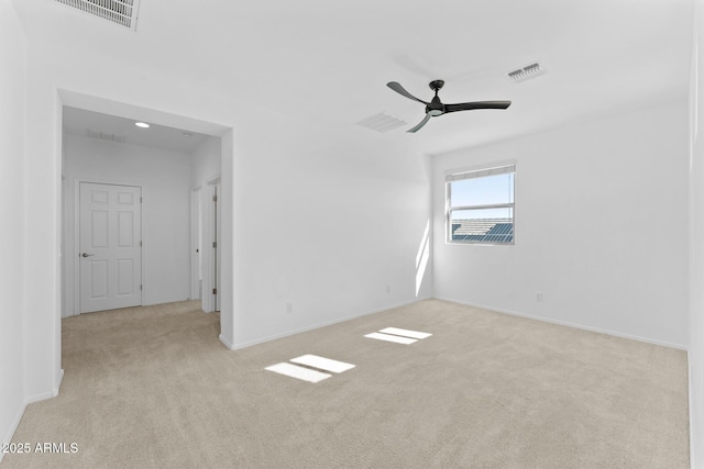 spare room featuring ceiling fan and light colored carpet