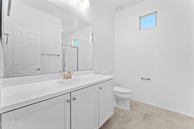 bathroom featuring a healthy amount of sunlight, toilet, a shower with door, and vanity