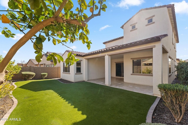 back of house featuring a patio and a lawn