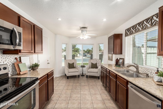 18219 N 19th St, Phoenix, AZ 85022 - kitchen featuring appliances with stainless steel finishes, a sink, decorative backsplash, a ceiling fan, and recessed lighting