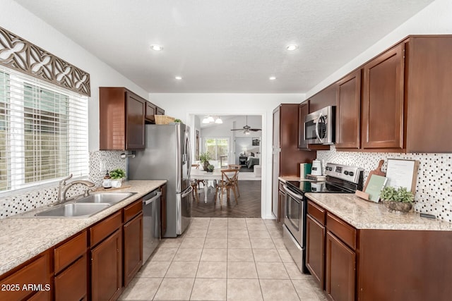 18219 N 19th St, Phoenix, AZ 85022 - kitchen with appliances with stainless steel finishes, a sink, a ceiling fan, tasteful backsplash, and light countertops