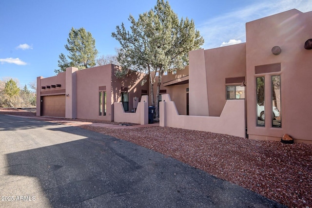 33 Monterey Cir, Sedona, AZ 86351 - view of front of property featuring an attached garage, stucco siding, and driveway