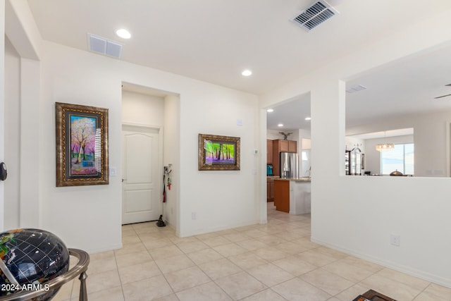 interior space with light tile flooring and a chandelier