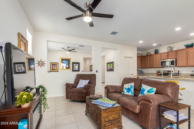 tiled living room featuring ceiling fan