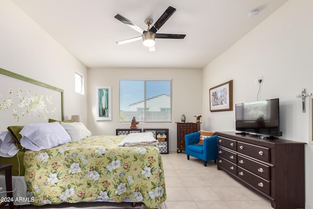 bedroom with ceiling fan and light tile floors