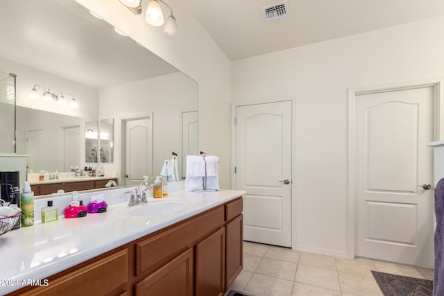 bathroom with tile floors and large vanity