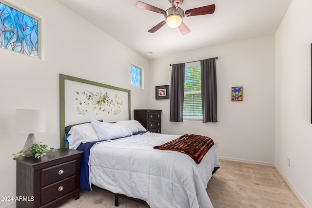 bedroom featuring light carpet and ceiling fan