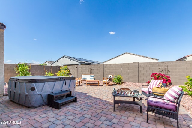 view of patio / terrace with a hot tub