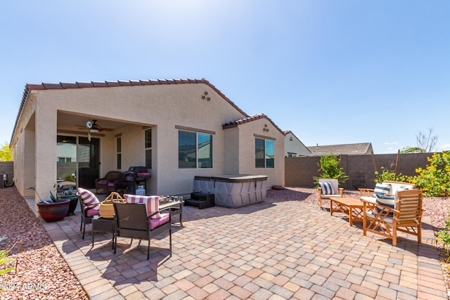 view of patio / terrace featuring ceiling fan, outdoor lounge area, and a hot tub