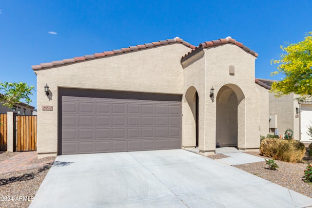 mediterranean / spanish-style house with a garage