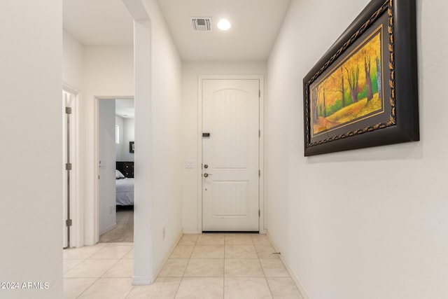 doorway to outside featuring light tile flooring