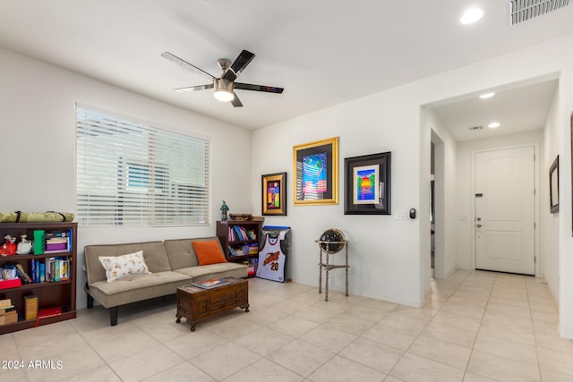 sitting room featuring ceiling fan and light tile floors