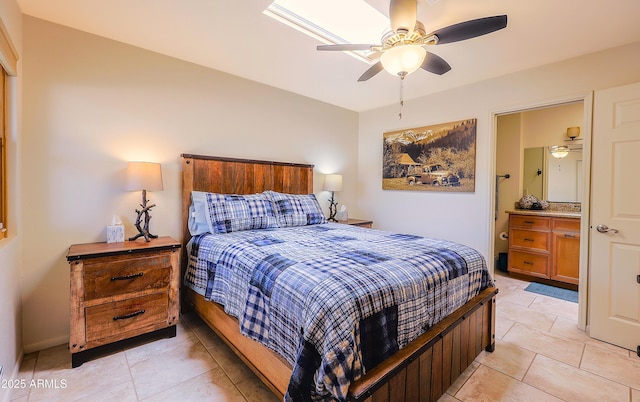 bedroom featuring connected bathroom, light tile patterned floors, and ceiling fan