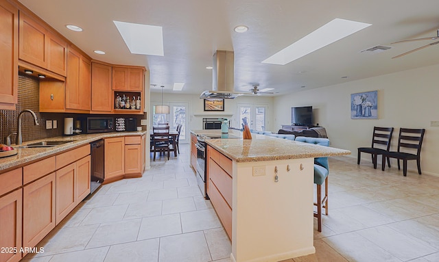 kitchen featuring a sink, a skylight, black dishwasher, visible vents, and range with electric cooktop
