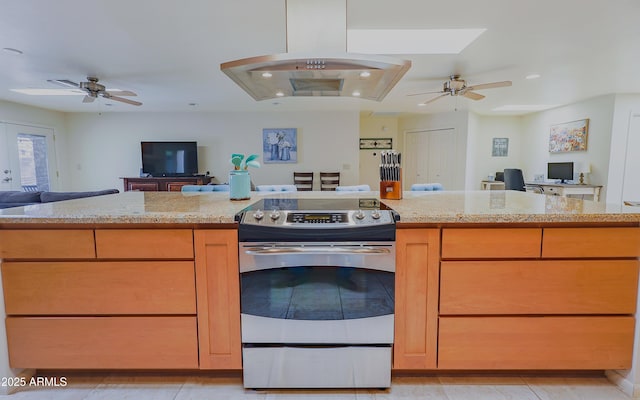 kitchen with ceiling fan, island range hood, open floor plan, and electric stove