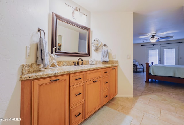 bathroom featuring vanity, ensuite bath, and a ceiling fan