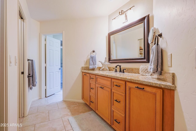 bathroom featuring baseboards, tile patterned floors, and vanity