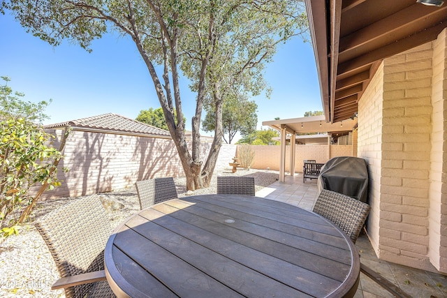 view of patio / terrace featuring a fenced backyard, outdoor dining space, and grilling area