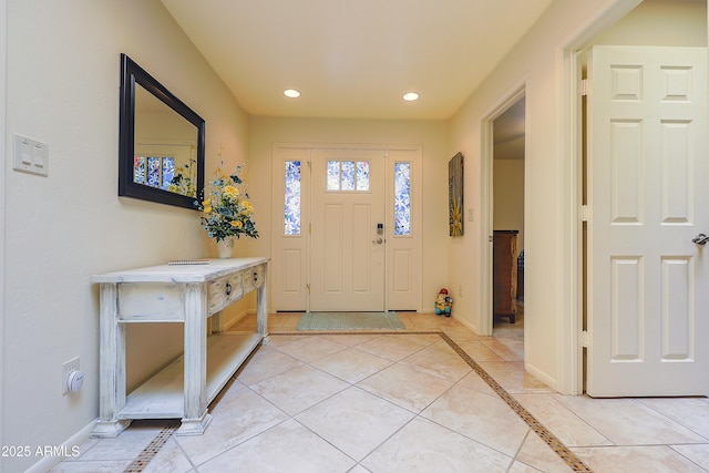 foyer with baseboards, light tile patterned floors, and recessed lighting