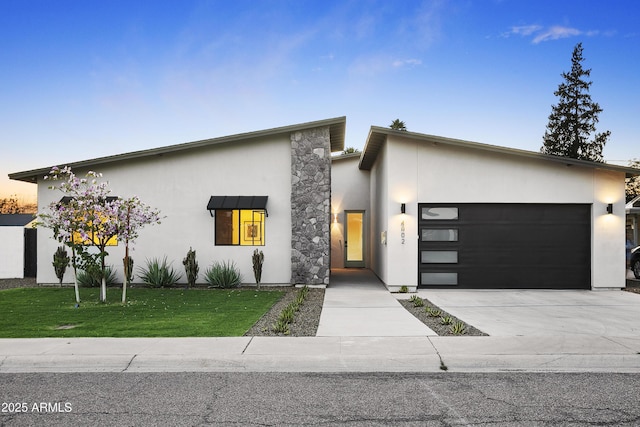 4002 N 33rd Pl, Phoenix, AZ 85018 - modern home featuring stucco siding, a garage, driveway, and a front lawn