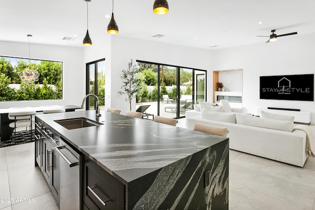 4002 N 33rd Pl, Phoenix, AZ 85018 - kitchen with a sink, dark cabinets, a kitchen island with sink, dishwasher, and pendant lighting