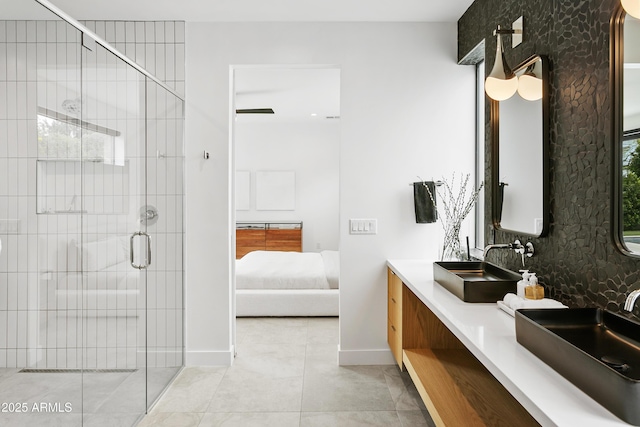 4002 N 33rd Pl, Phoenix, AZ 85018 - ensuite bathroom featuring tile patterned flooring, a stall shower, tasteful backsplash, double vanity, and baseboards