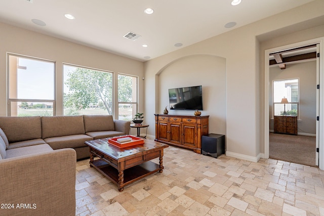 living room with a wealth of natural light and light tile floors