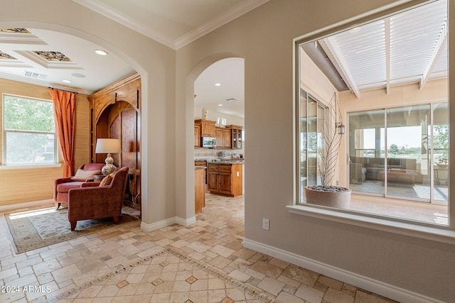 hall featuring light tile floors and crown molding