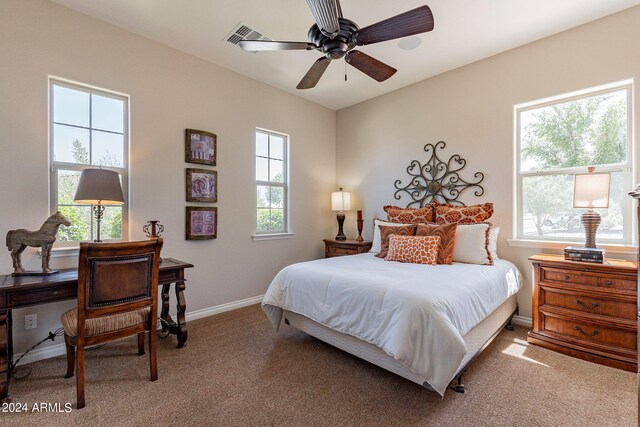 bedroom featuring carpet floors, multiple windows, and ceiling fan