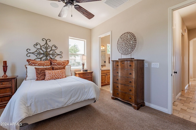 tiled bedroom with ceiling fan and connected bathroom