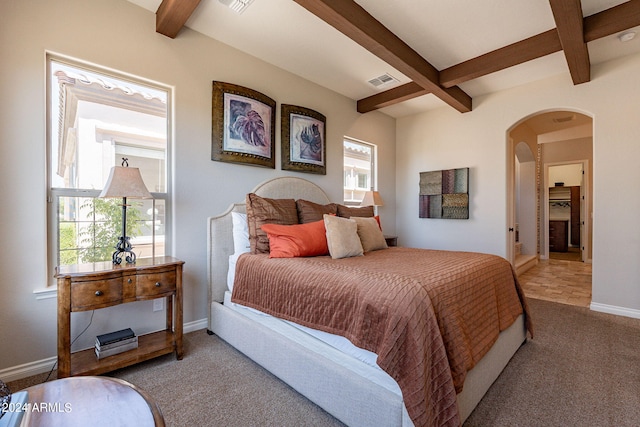 tiled bedroom featuring beam ceiling