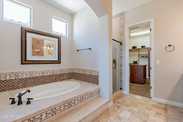 bathroom with independent shower and bath and tile flooring