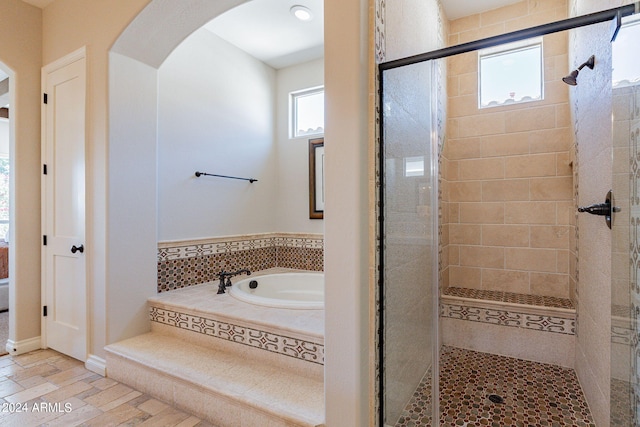 bathroom with tile flooring and separate shower and tub