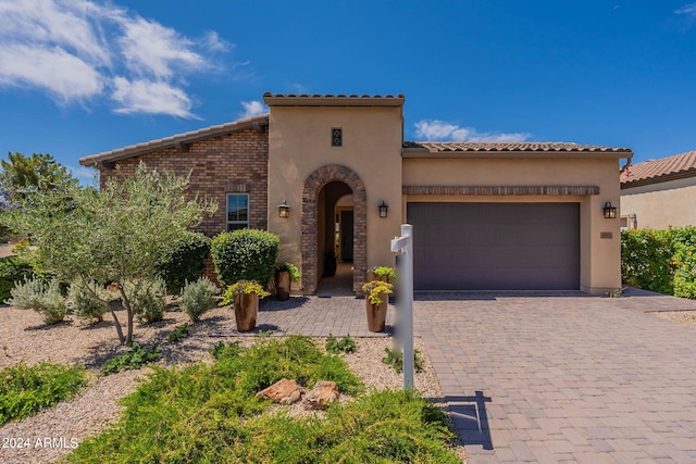 mediterranean / spanish house with a garage