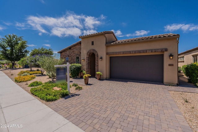 mediterranean / spanish-style house featuring a garage