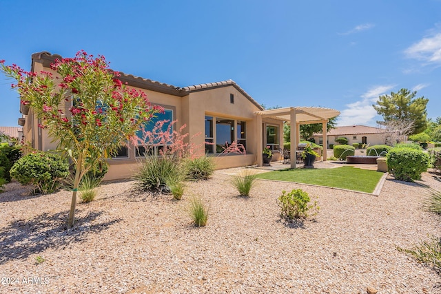 back of property featuring a pergola and a patio area