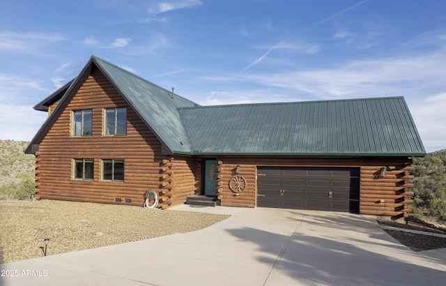4177 W Finch Hollow Ave, Chino Valley, AZ 86323 - cabin with an attached garage, driveway, log siding, and metal roof