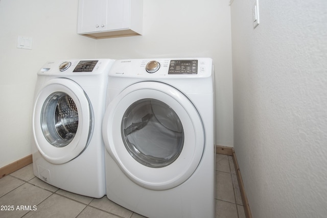 4177 W Finch Hollow Ave, Chino Valley, AZ 86323 - laundry area with cabinet space, washing machine and clothes dryer, baseboards, and light tile patterned floors
