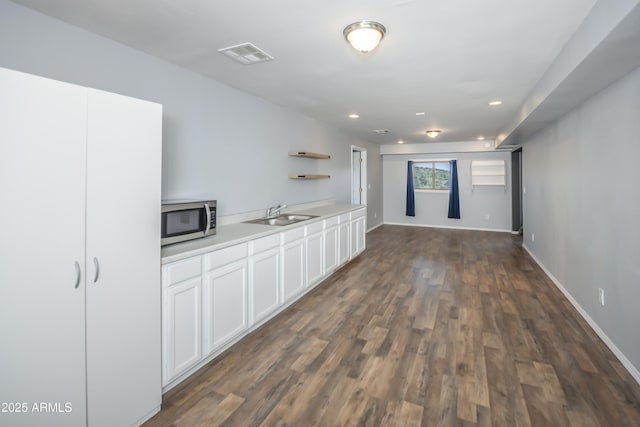 4177 W Finch Hollow Ave, Chino Valley, AZ 86323 - interior space featuring open shelves, a sink, light countertops, stainless steel microwave, and visible vents