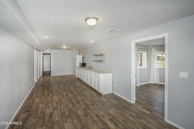 4177 W Finch Hollow Ave, Chino Valley, AZ 86323 - kitchen with white cabinets, dark wood finished floors, baseboards, visible vents, and light countertops