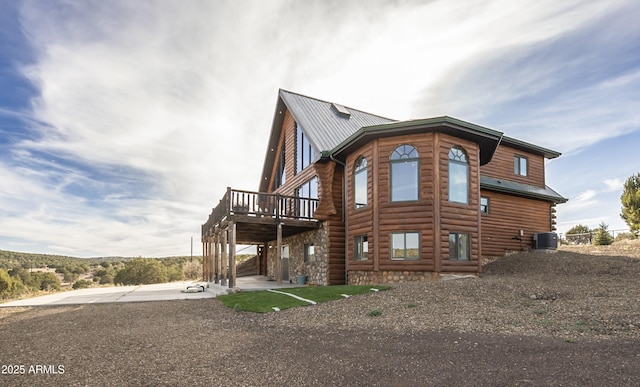 4177 W Finch Hollow Ave, Chino Valley, AZ 86323 - view of home's exterior with central air condition unit, metal roof, and a deck
