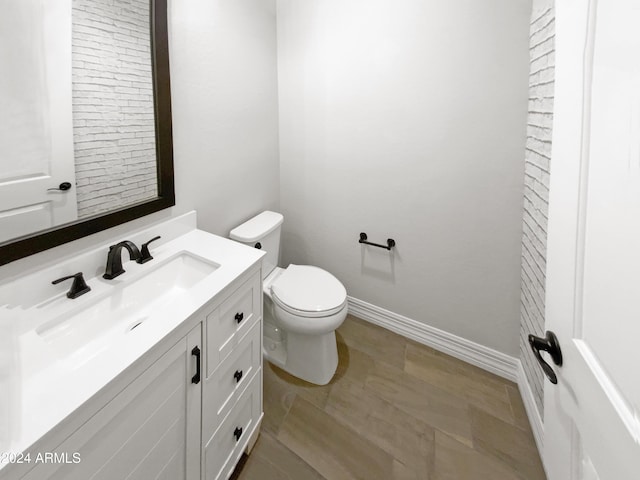 bathroom featuring hardwood / wood-style floors, vanity, and toilet