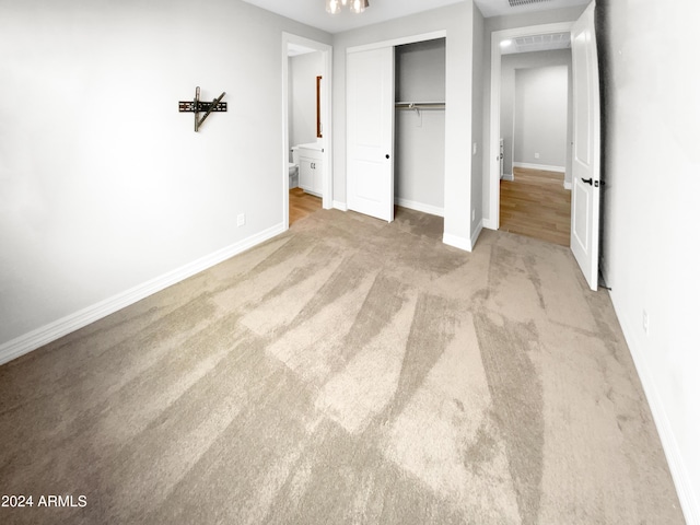 unfurnished bedroom featuring carpet flooring and a closet