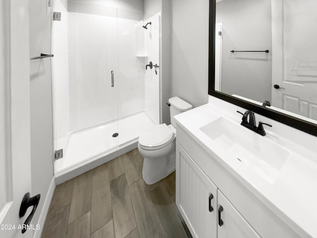 bathroom with vanity, toilet, and an enclosed shower