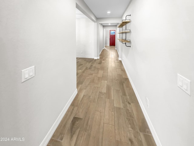 corridor with light hardwood / wood-style flooring