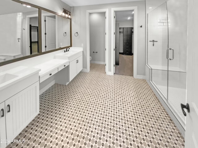 bathroom with toilet, vanity, and walk in shower