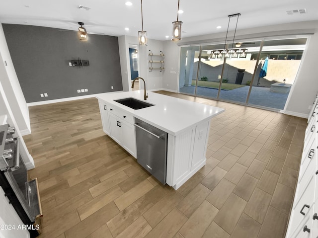 kitchen featuring a center island with sink, dishwasher, pendant lighting, and sink